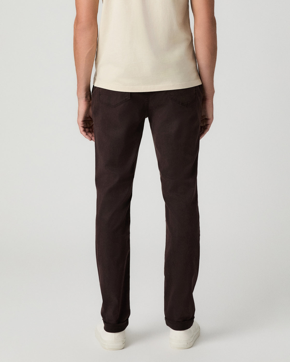 Back view from the waist down of the Fraser Pant in Mole, worn with white sneakers