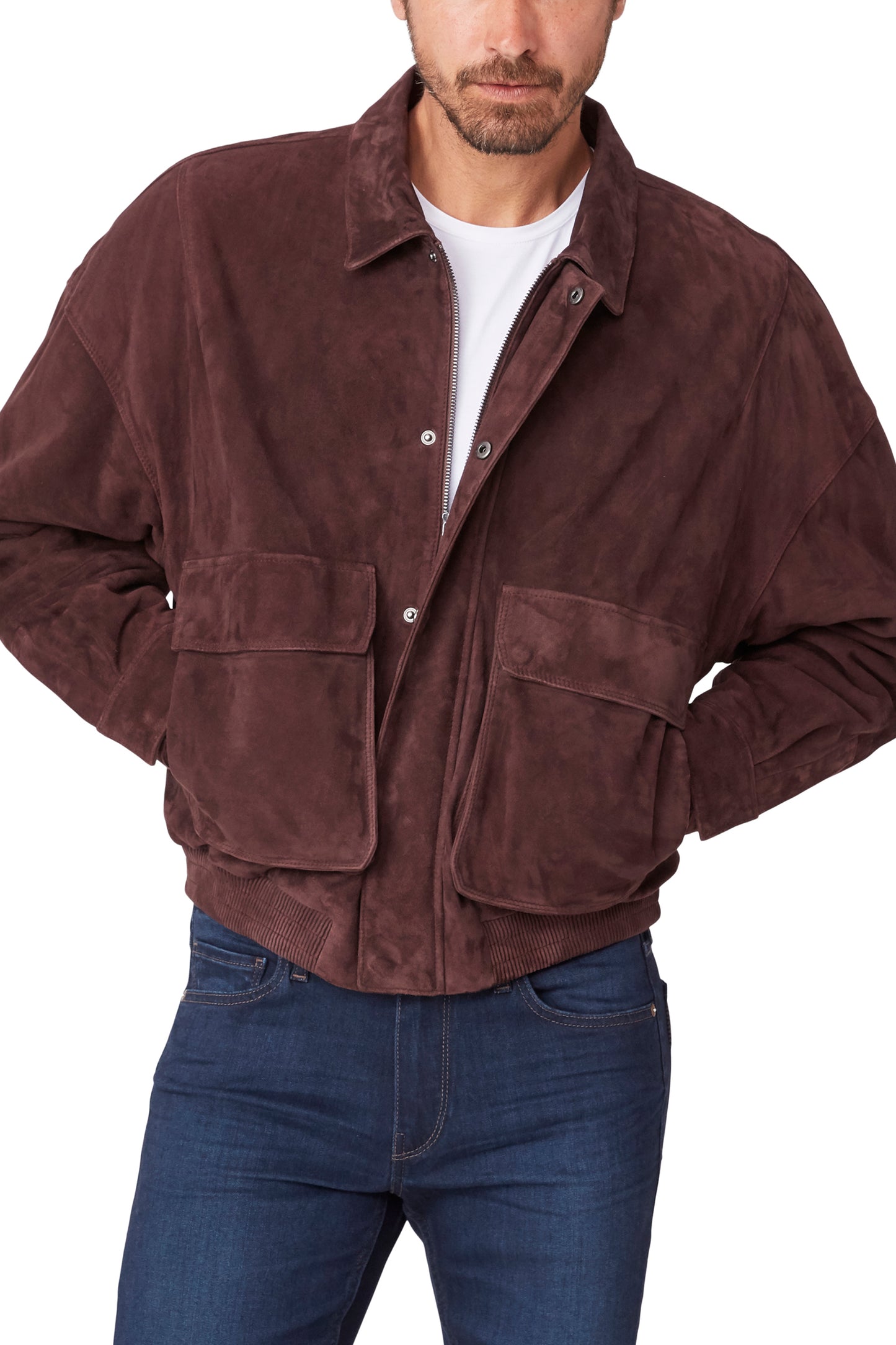 Man wearing a brown suede jacket and blue jeans on a white background