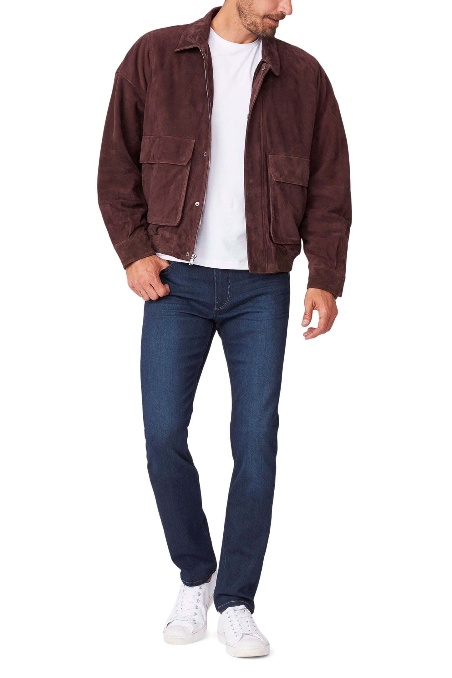 Man wearing a brown jacket, white shirt, blue jeans, and white sneakers on a white background