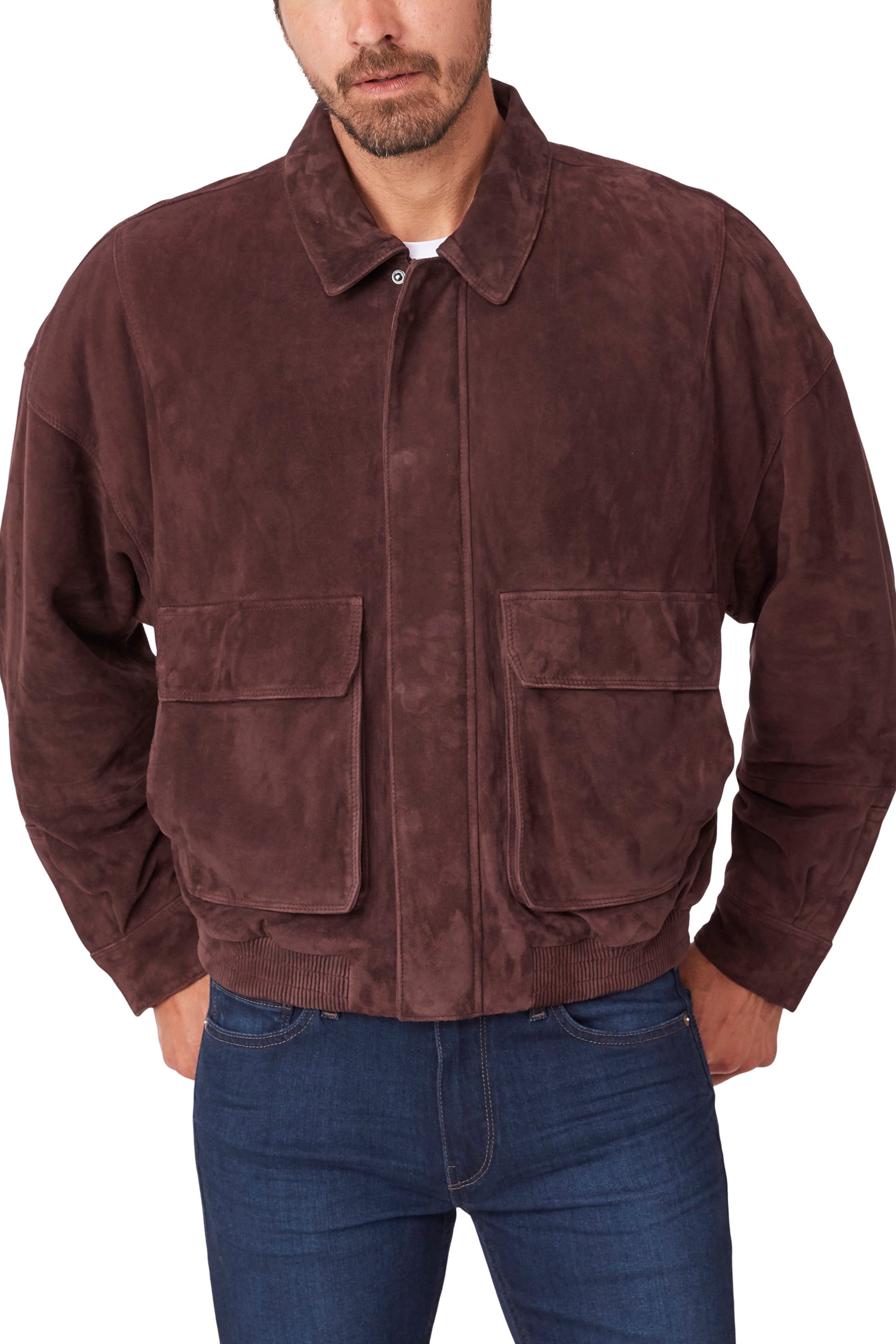 Man wearing a brown suede jacket and blue jeans on a white background