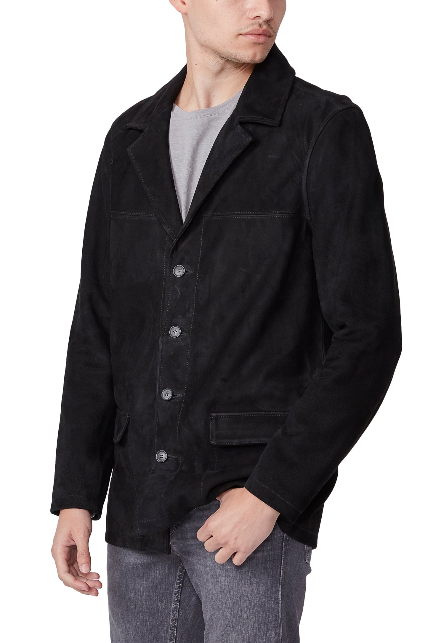 Man wearing a black jacket over a gray shirt on a white background