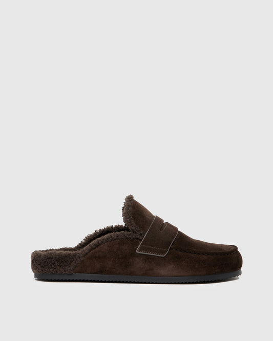 Chocolate color slipper with shearling lining on a light gray background