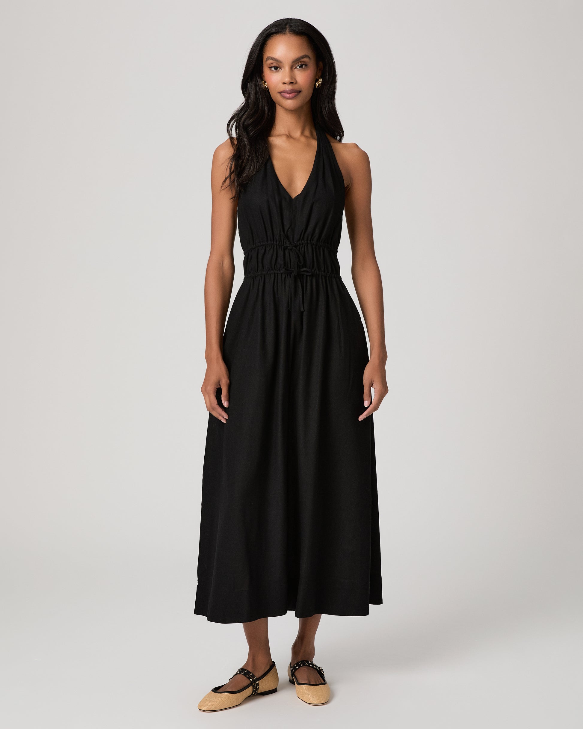 Woman wearing a black sleeveless dress on a white background