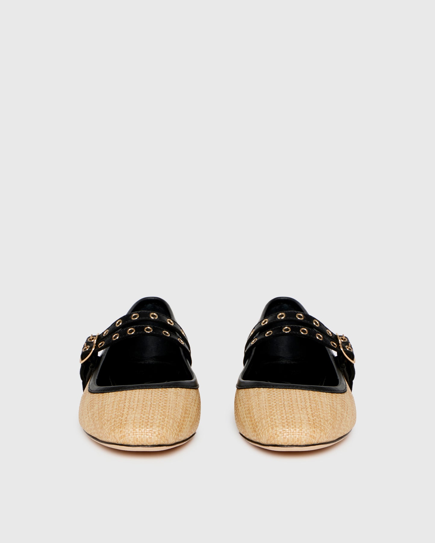 Two-tone shoe with straw-like material and black accents on a light gray background