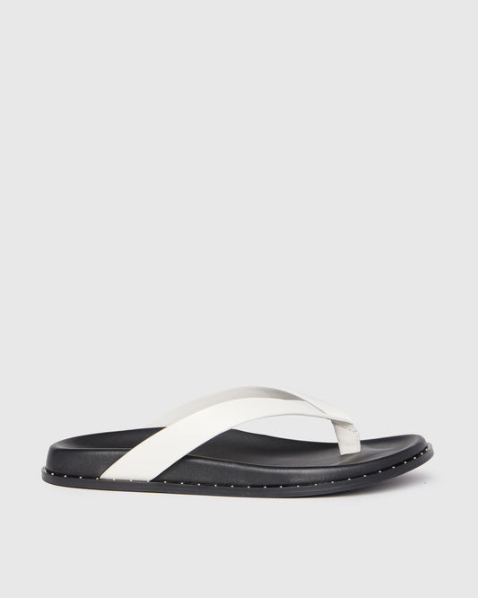 Black and white sandal on a light gray background
