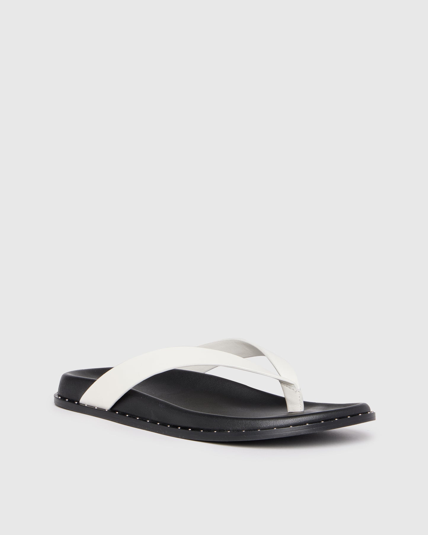 Black and white sandal on a light gray background