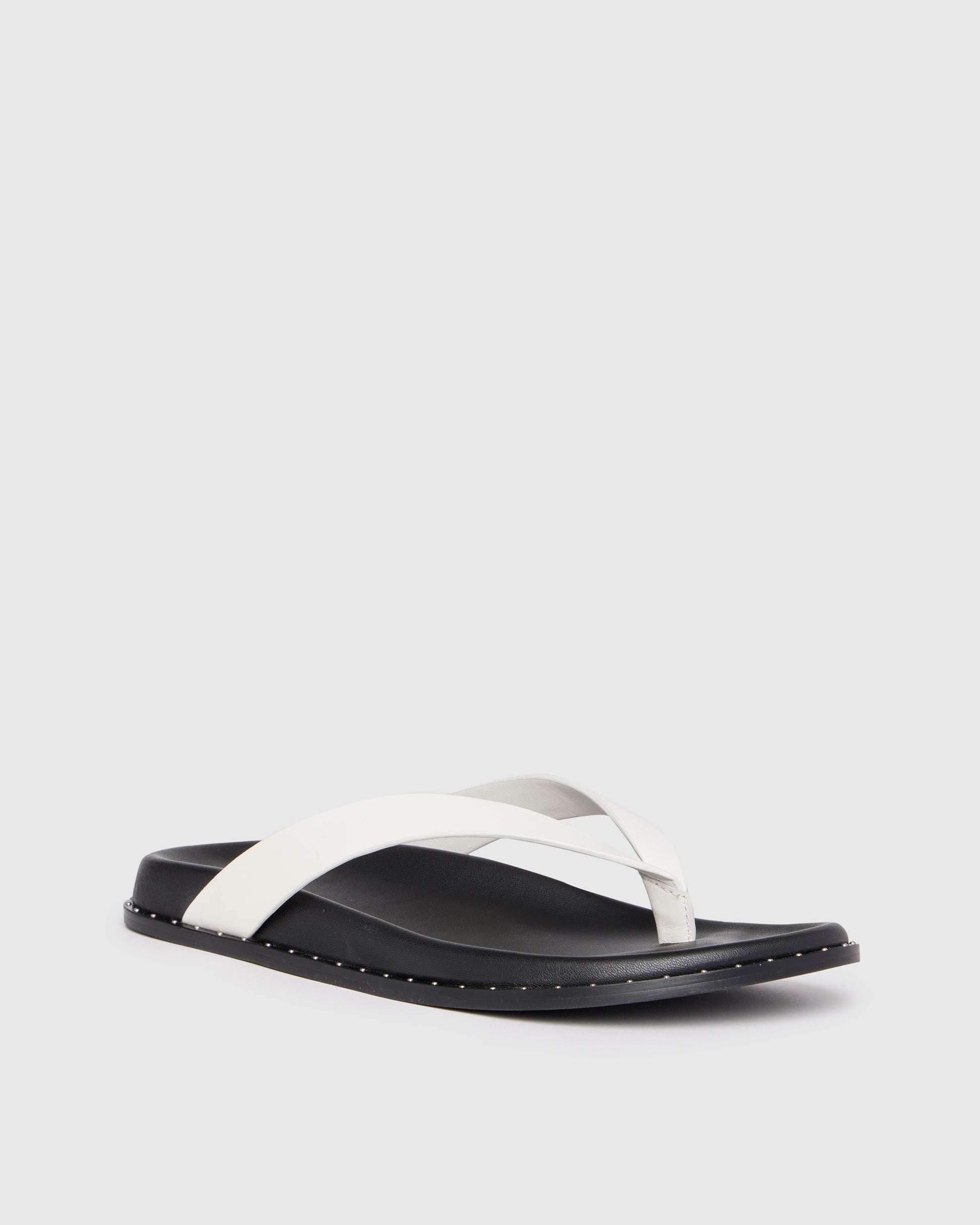 Black and white sandal on a light gray background