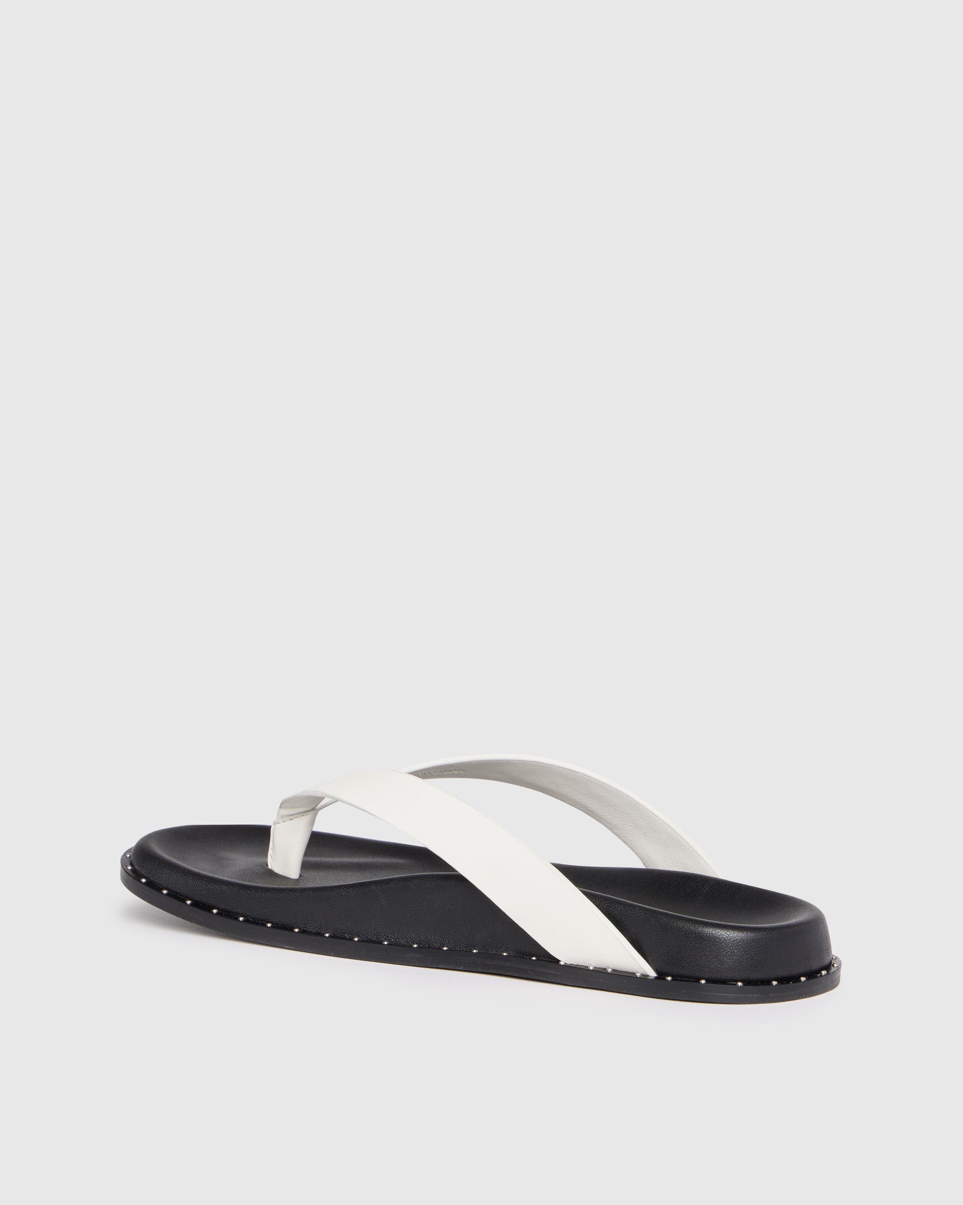 Black and white sandal on a light gray background