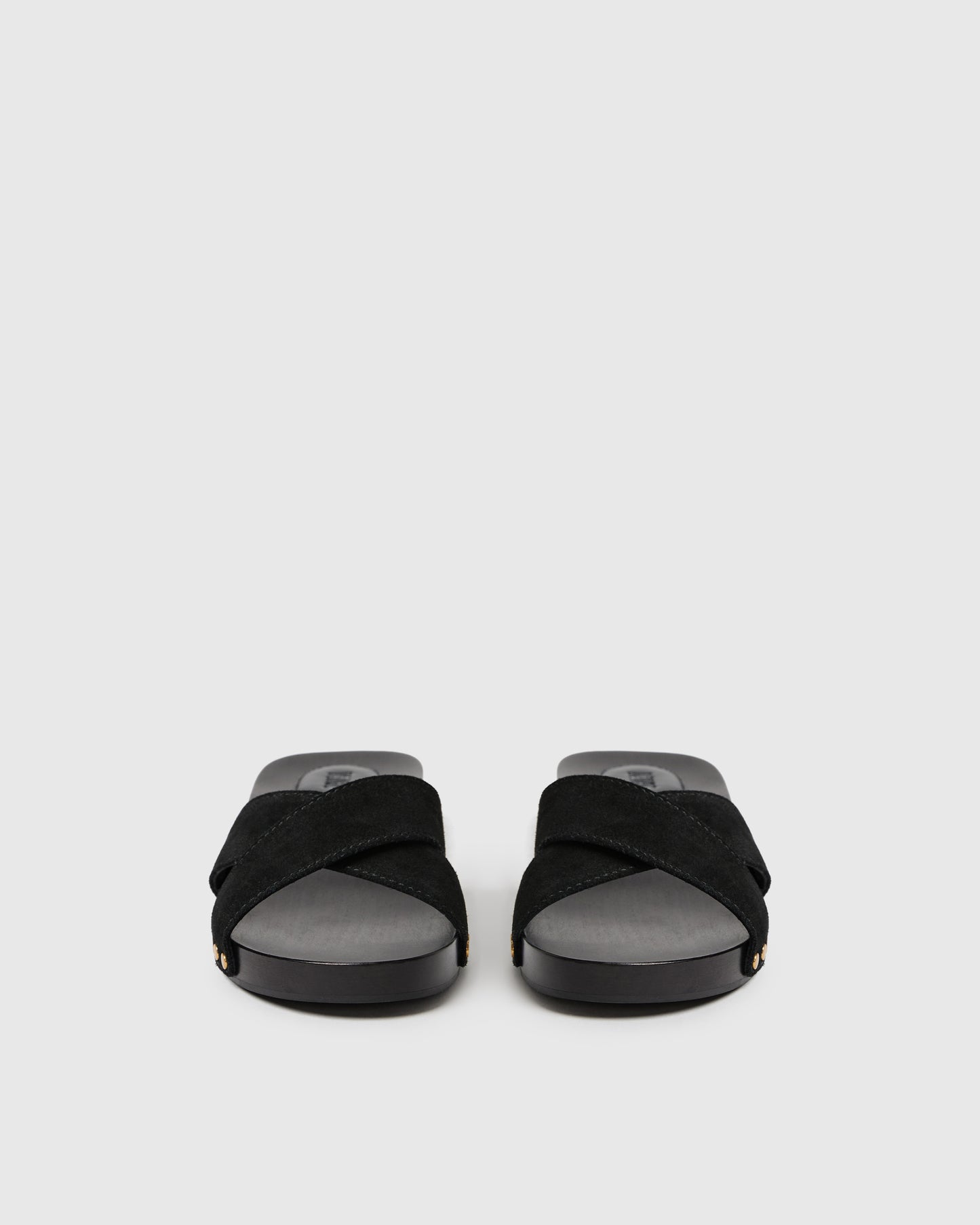 Black sandals with gray soles on a light gray background