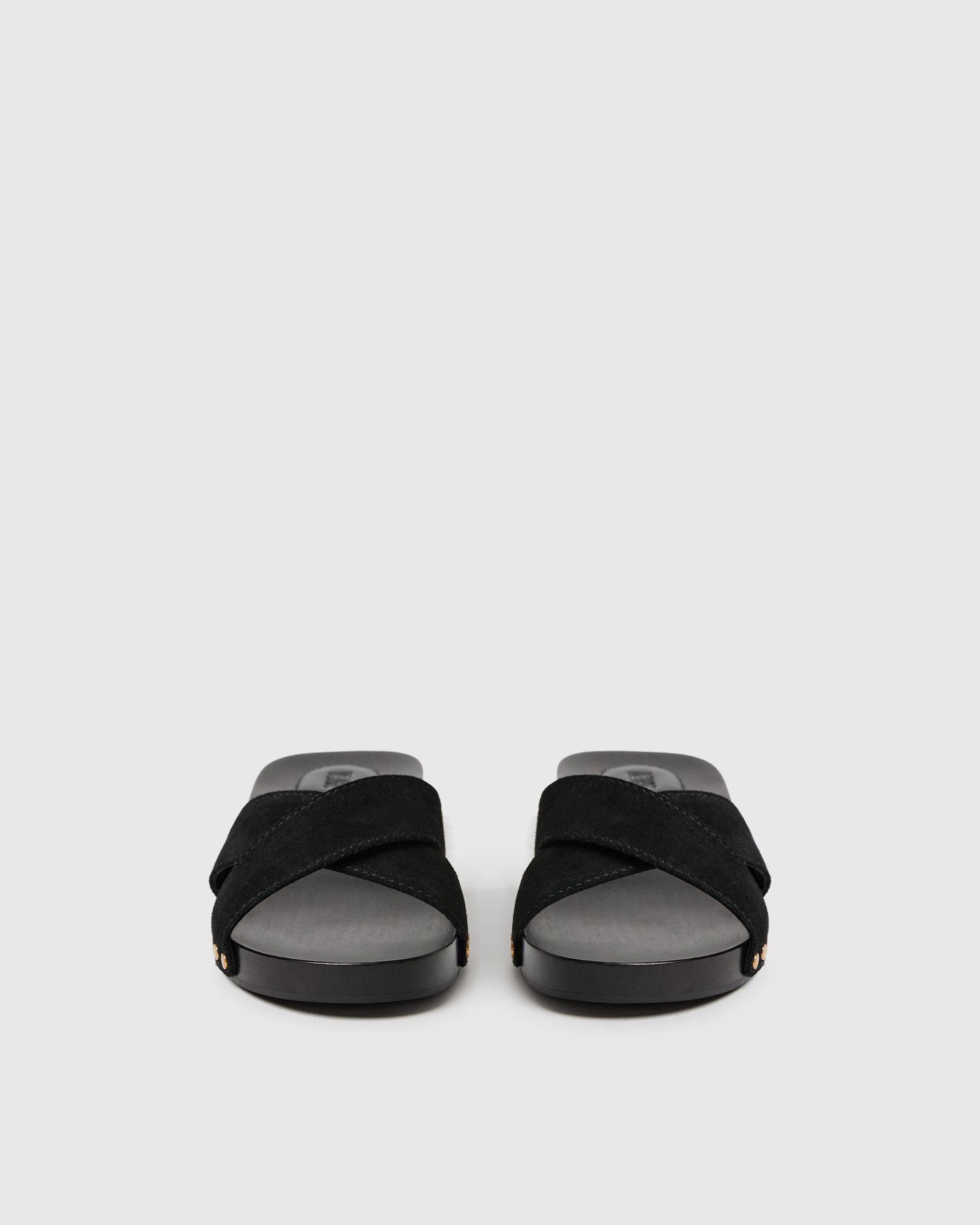 Black sandals with gray soles on a light gray background