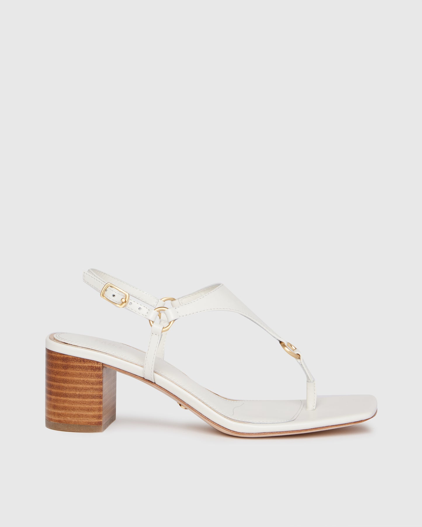 White sandal with wooden heel on a light gray background