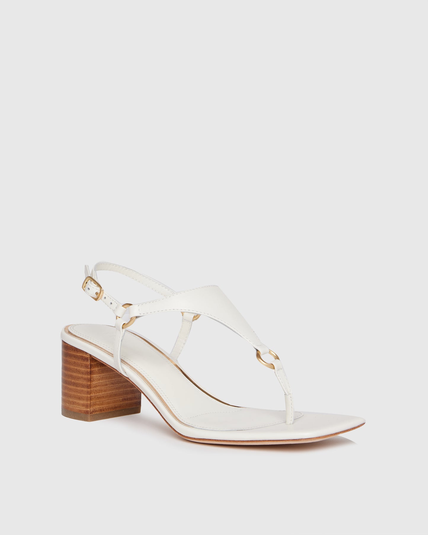White sandal with wooden heel on a light gray background