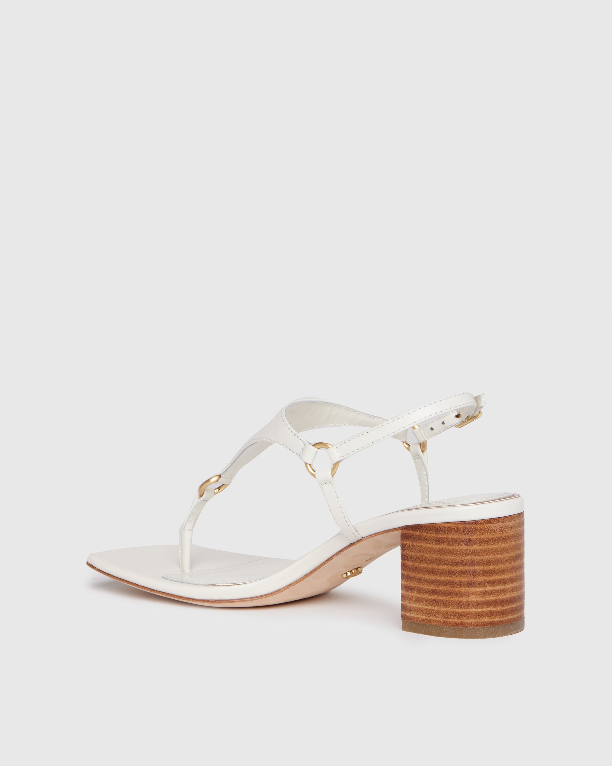 White sandal with wooden heel on a light gray background