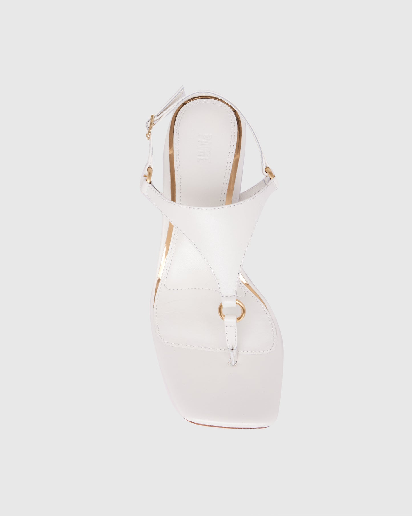 White sandal with wooden heel on a light gray background