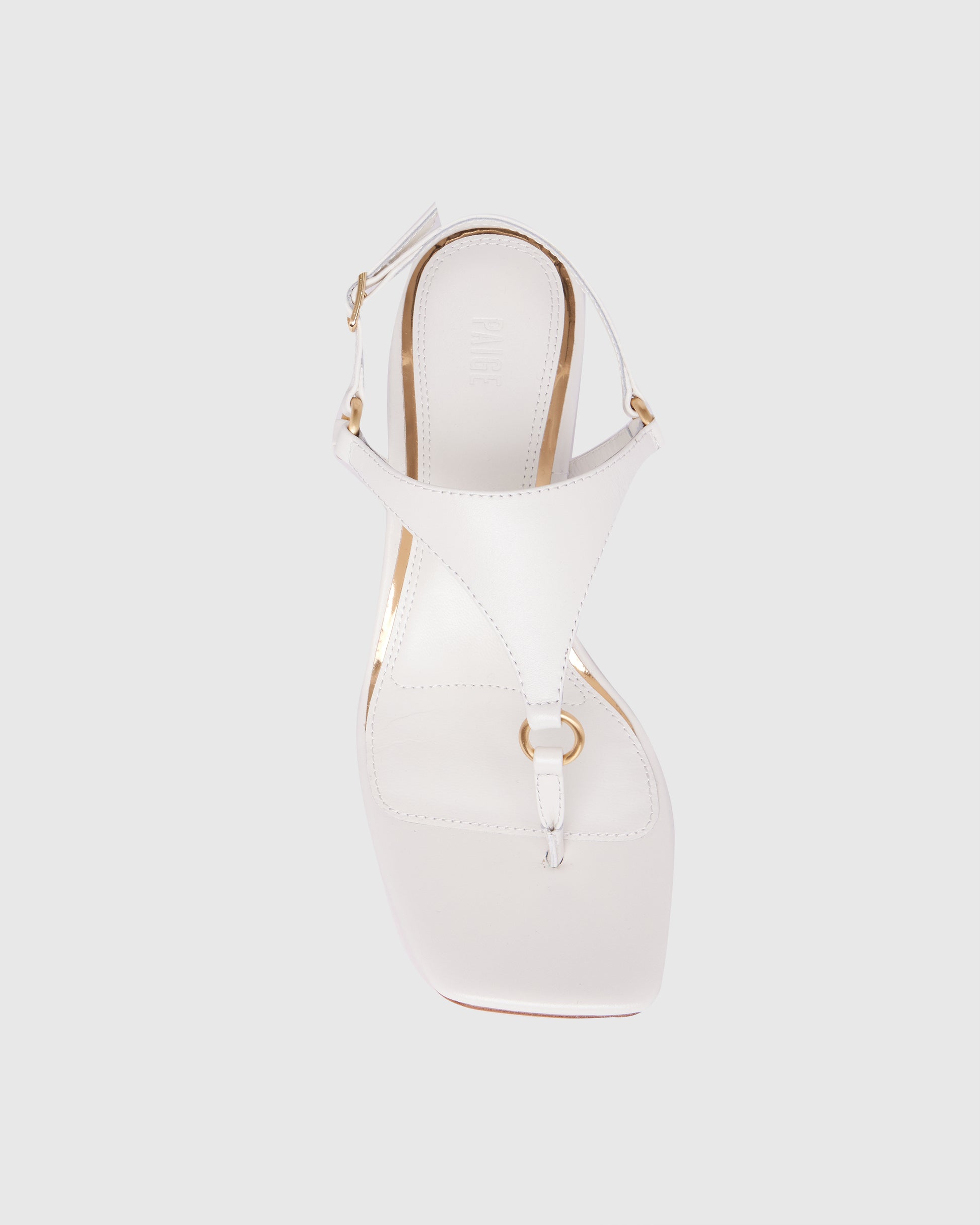 White sandal with wooden heel on a light gray background
