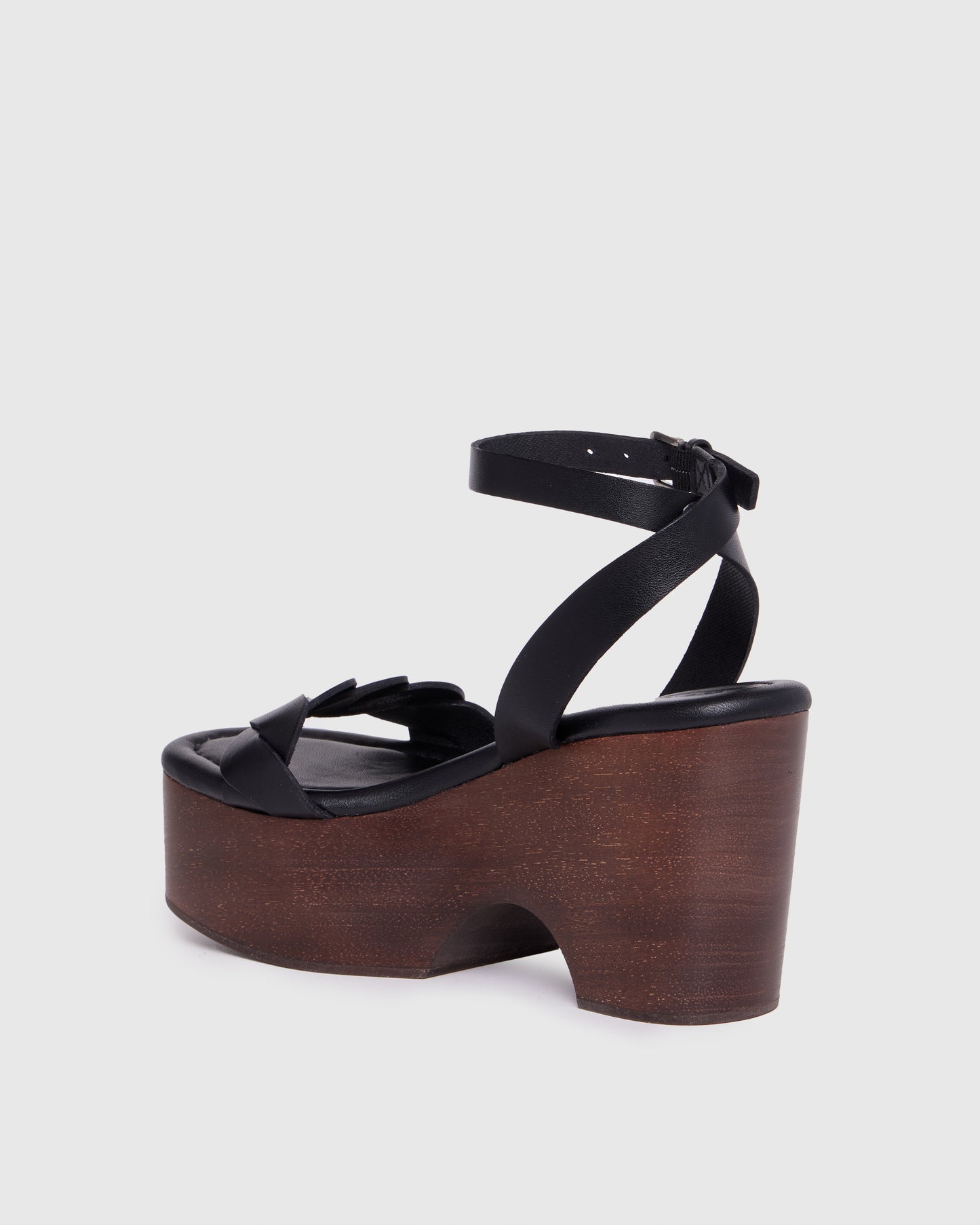 Black wedge sandal with wooden sole on a light gray background