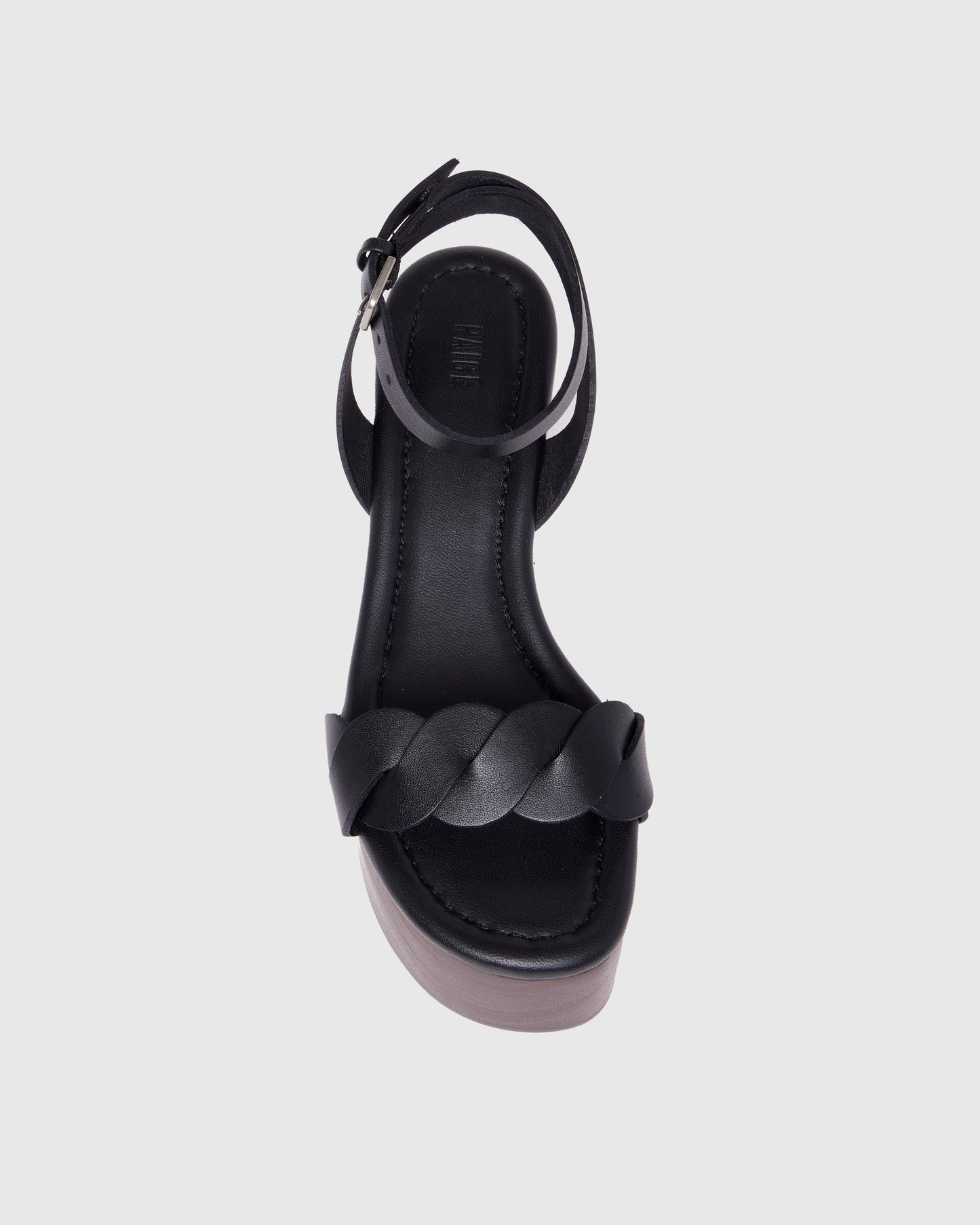 Black wedge sandal with wooden sole on a light gray background