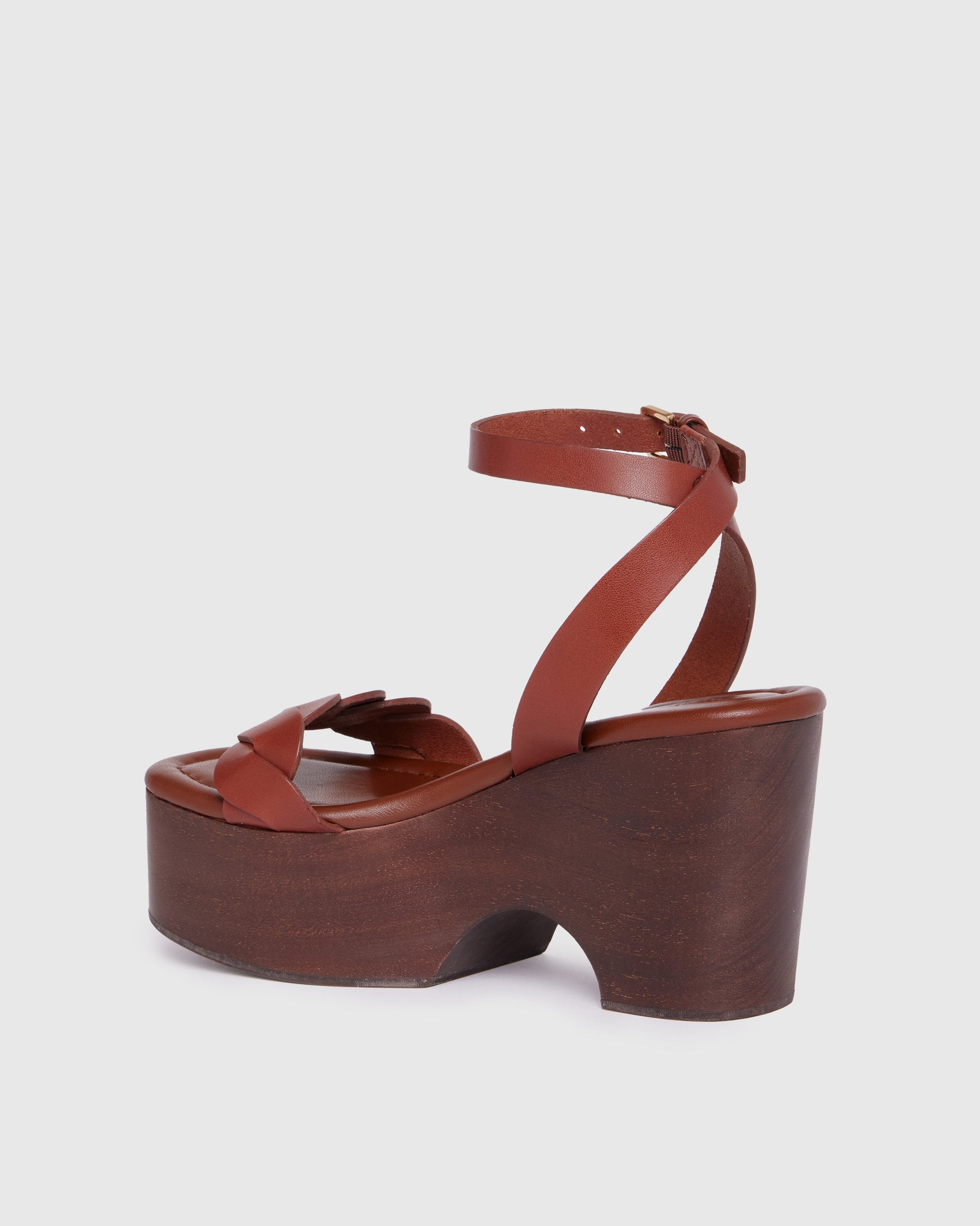 Brown platform sandal with wooden sole on a white background