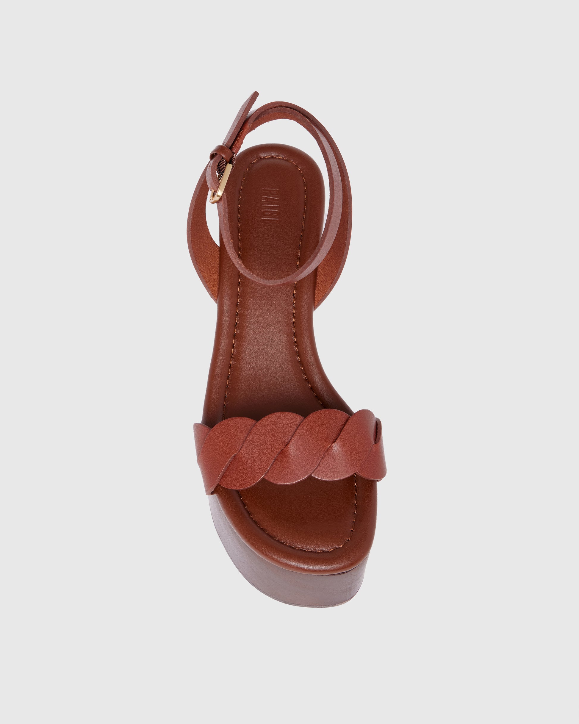Brown platform sandal with wooden sole on a light gray background